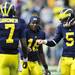 Quarterbacks freshman Devin Gardner, sophomore Denard Robinson and sophomore Tate Forcier all come together for a fist bump at the end of pregame against Massachusetts at Michigan Stadium on Saturday. Melanie Maxwell I AnnArbor.com

